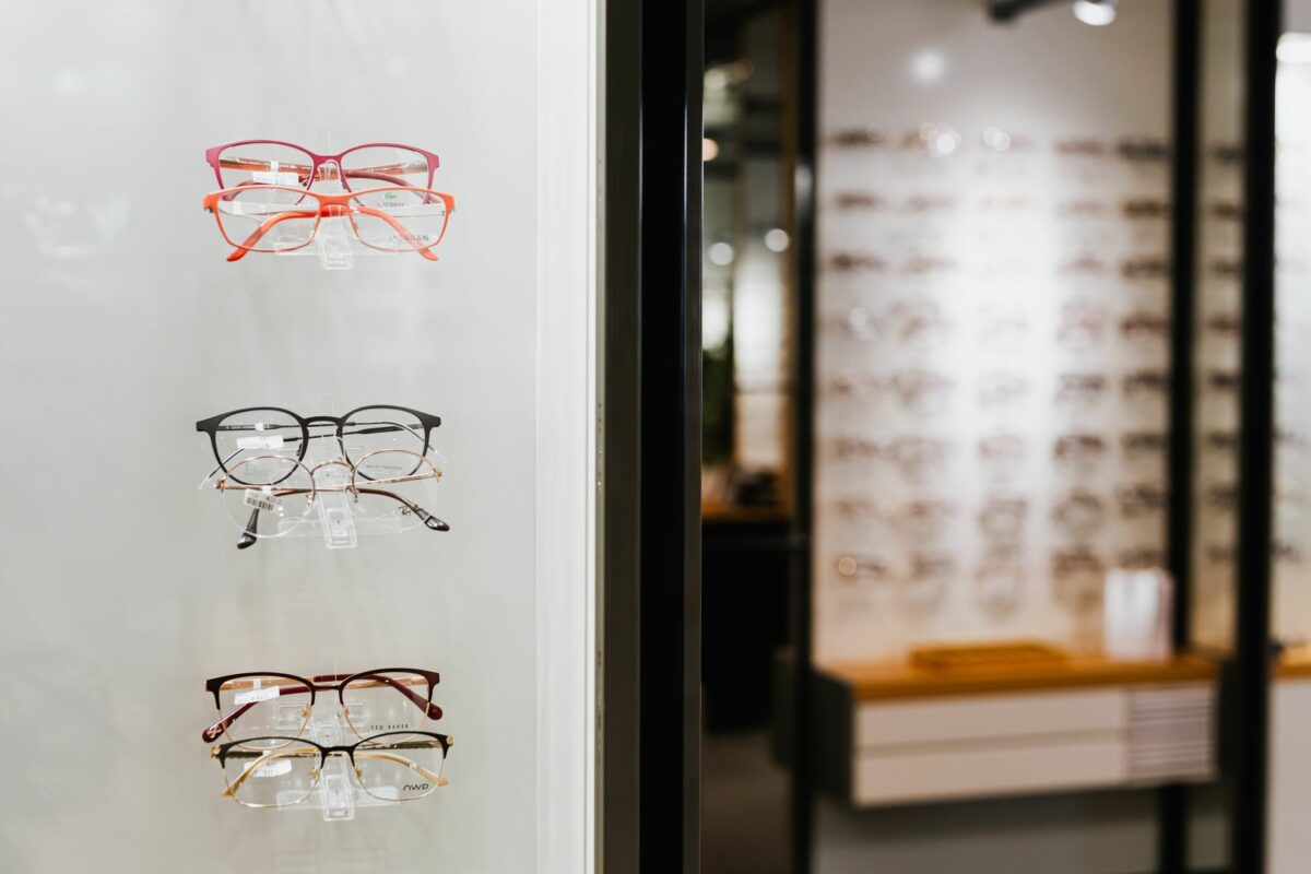 Variety of eyeglasses showcased on wall display in an optical store.